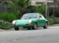 1970 porsche 911T 2.2 driving through leaves on a December day