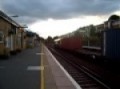 66517 works and clags past Kensington Olympia with Freightliner Intermodal