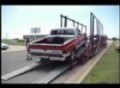 Driver Loads Vehicle onto Trailer
